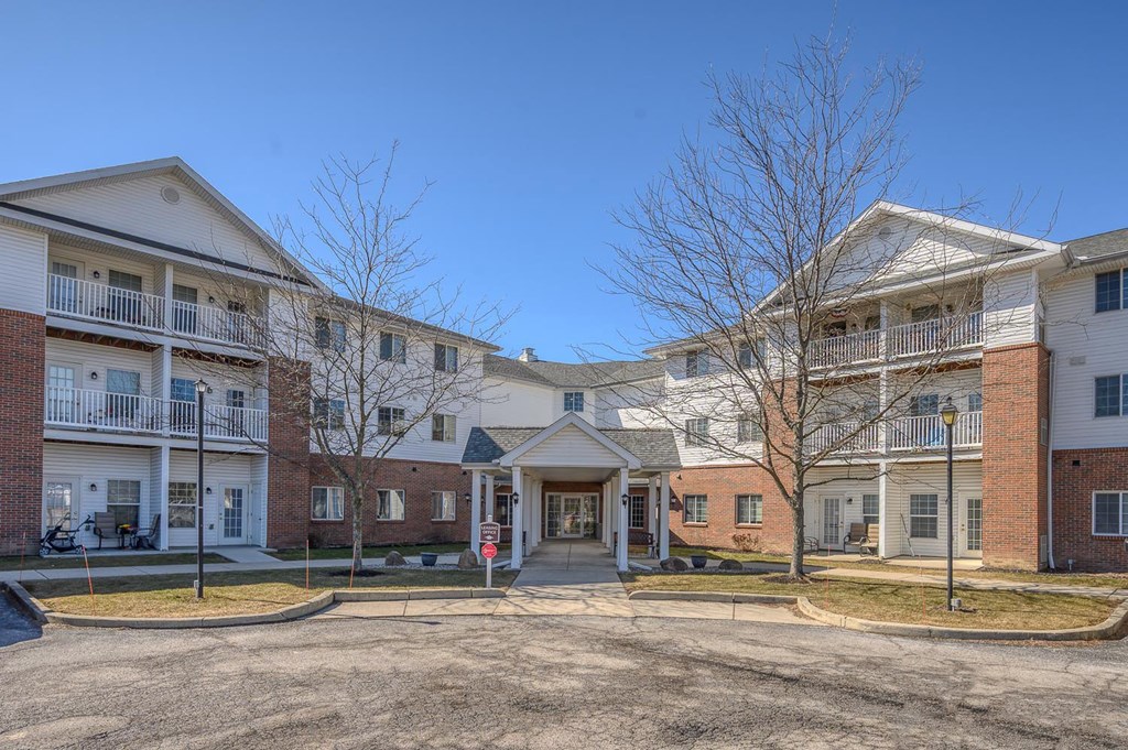Apartment complex with a mix of brick and siding exteriors.