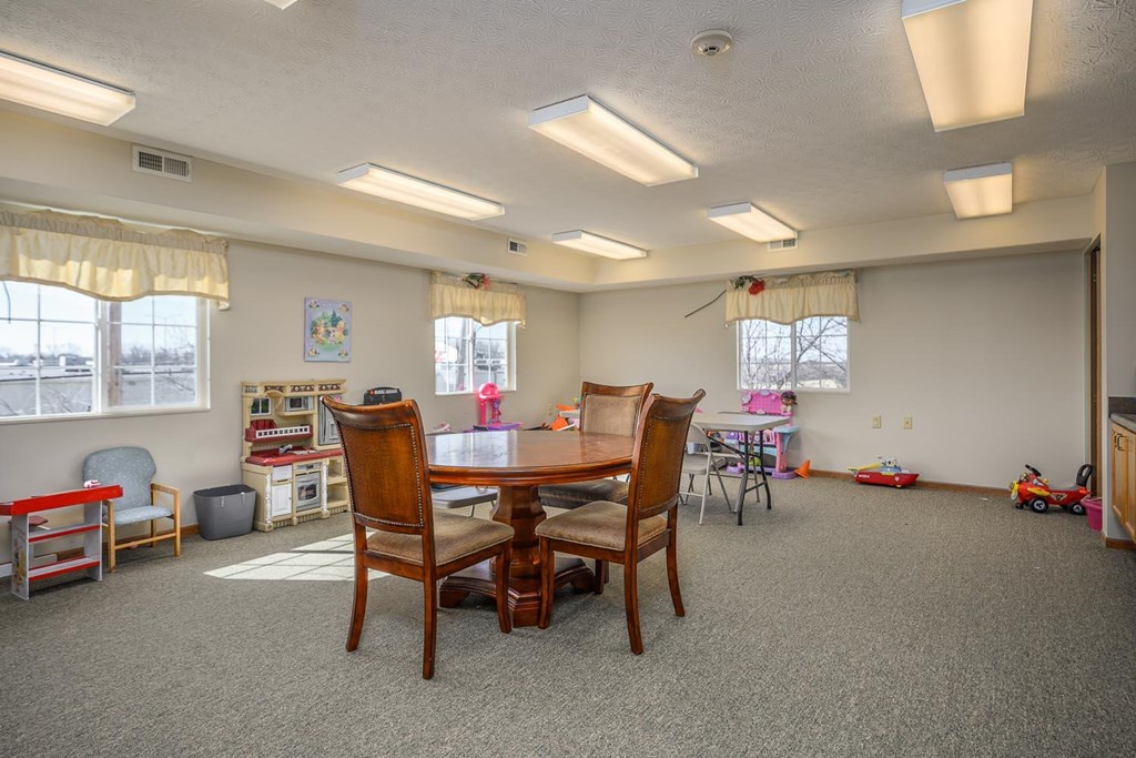 A room with a table and chairs in it.