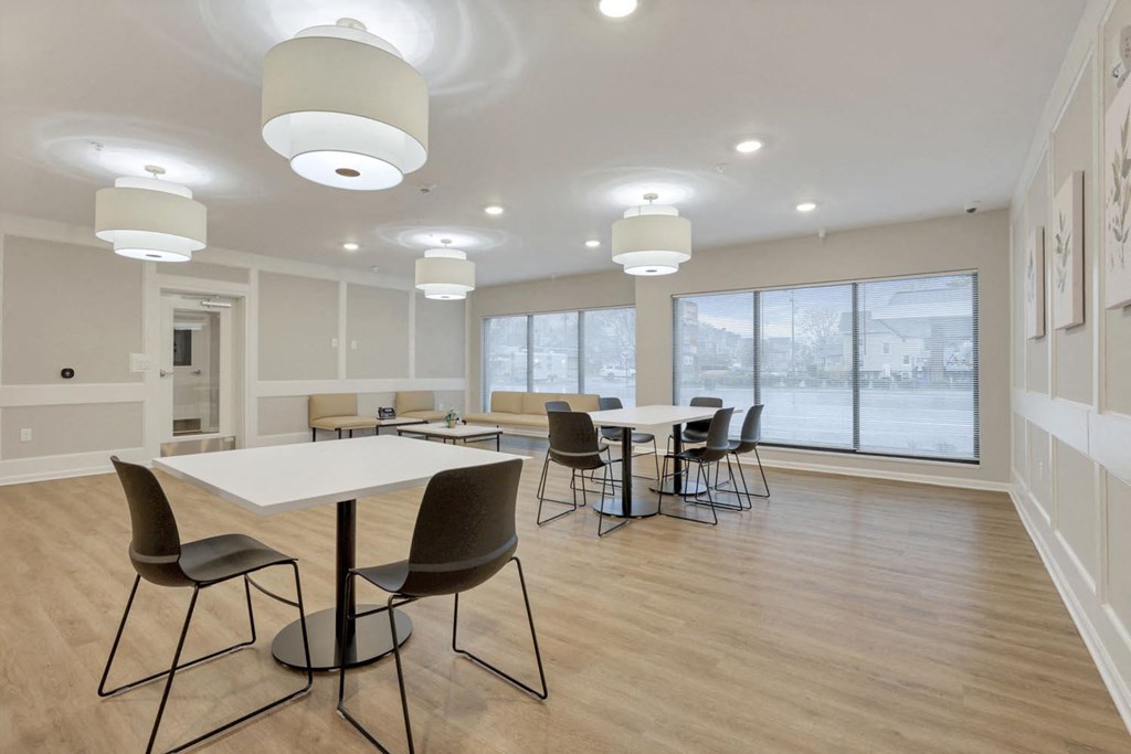 a dining room with tables and chairs and a large window