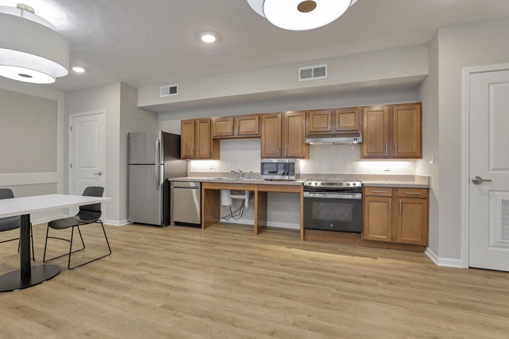 a kitchen with wooden cabinets and stainless steel appliances