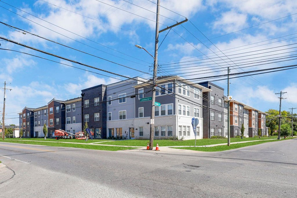 a row of new apartment buildings on a street corner