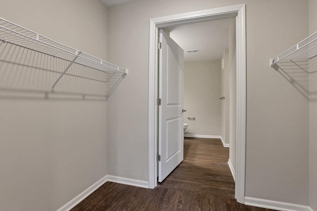 a bedroom with a closet and a door to a bathroom