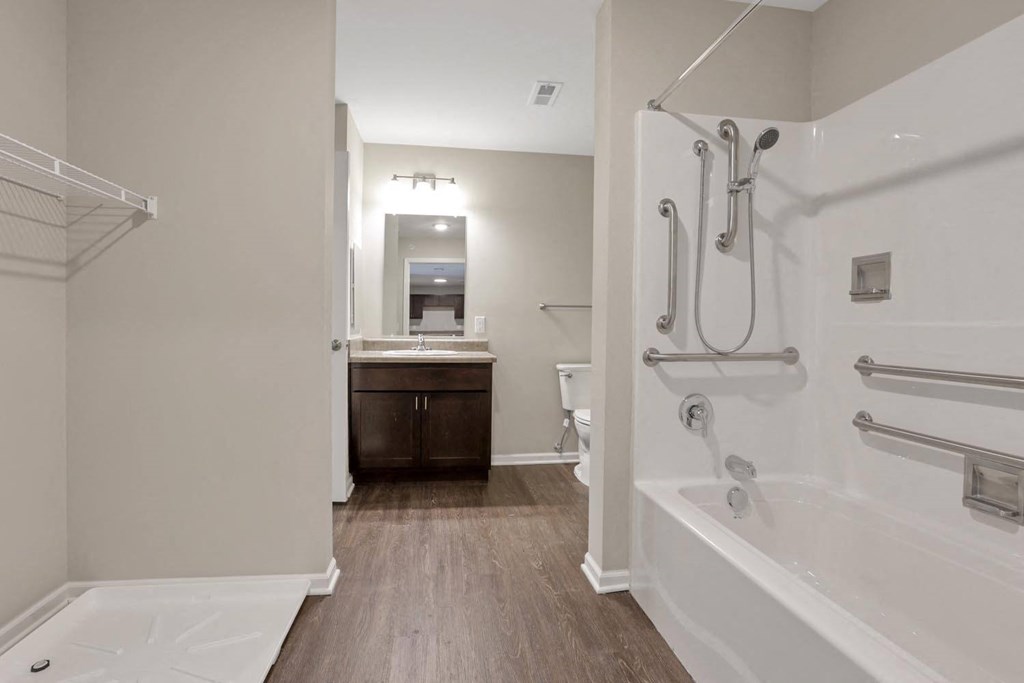 a bathroom with a tub and a sink and a mirror