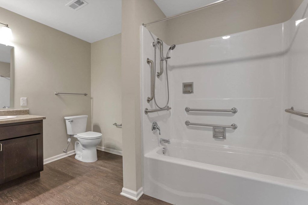 a bathroom with a shower and a toilet and a sink