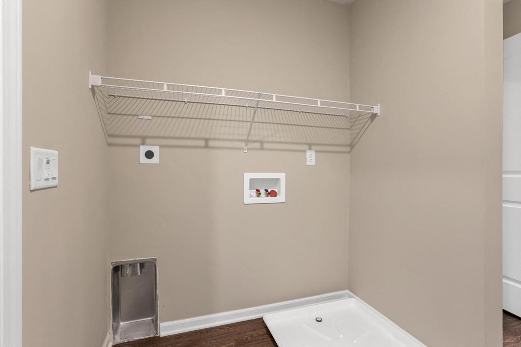 a white shelf is hanging on the wall above a bathroom sink