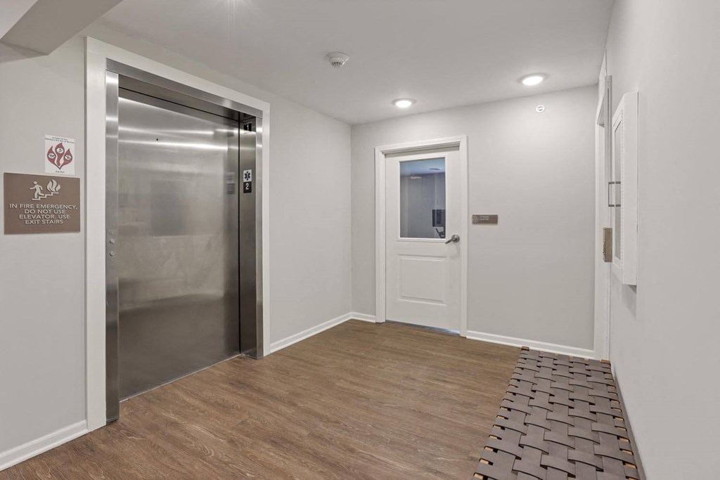 a white room with a door to a bathroom and a closet