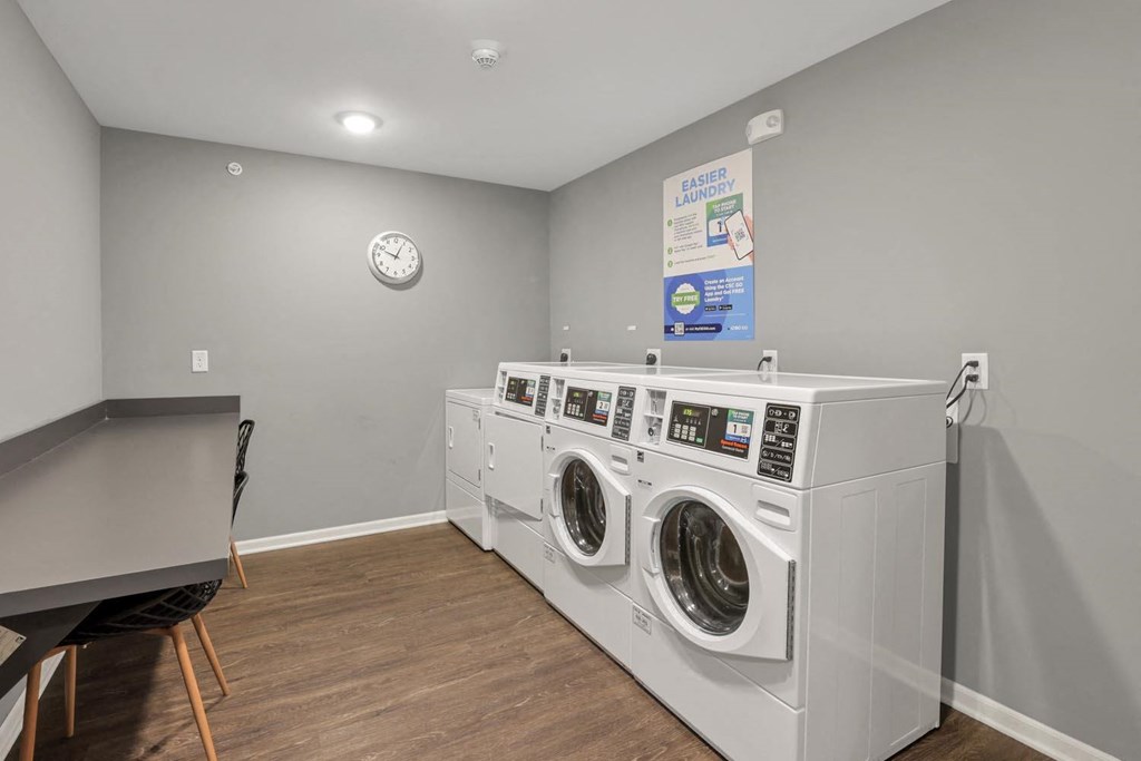 a laundry room with two washing machines and a table