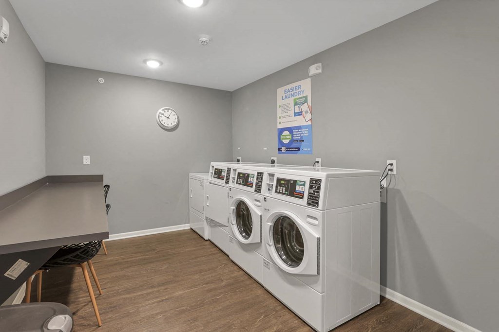 a laundry room with two washing machines and a table