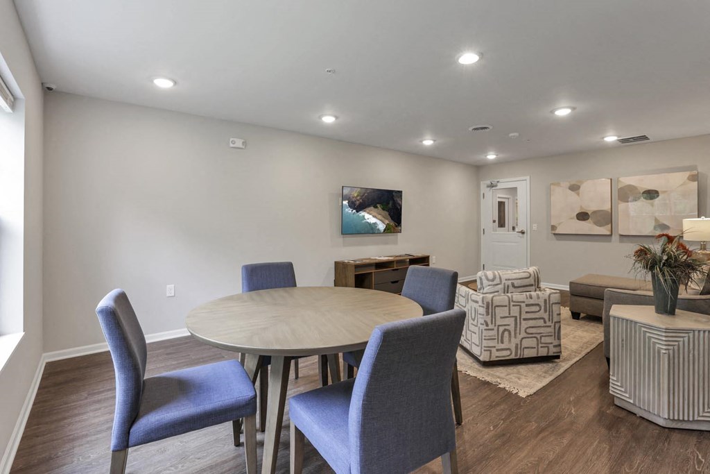 a dining room and living room with a table and chairs