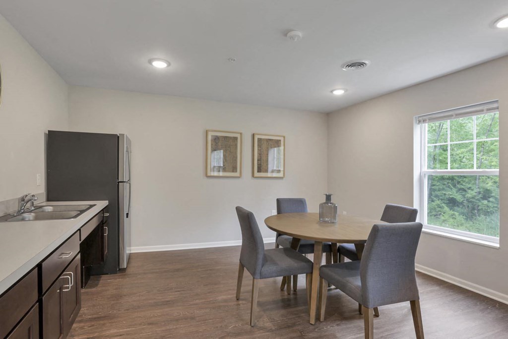 a kitchen and dining room with a table and chairs