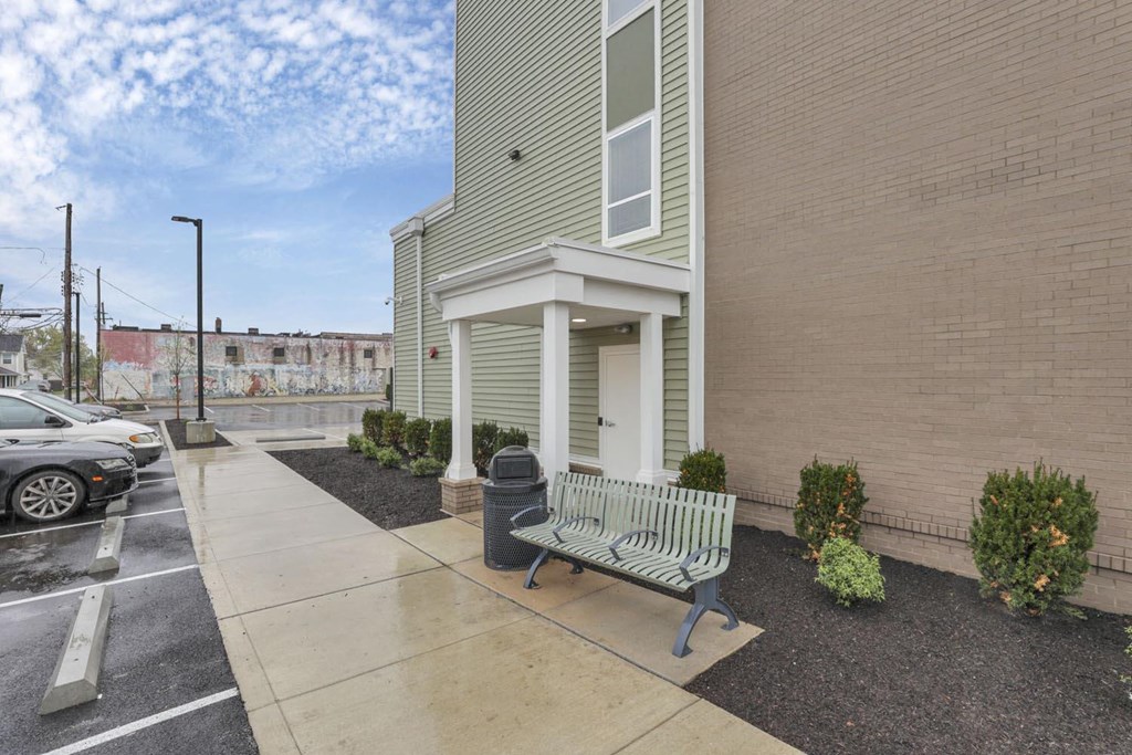 a bench in front of a building on a sidewalk