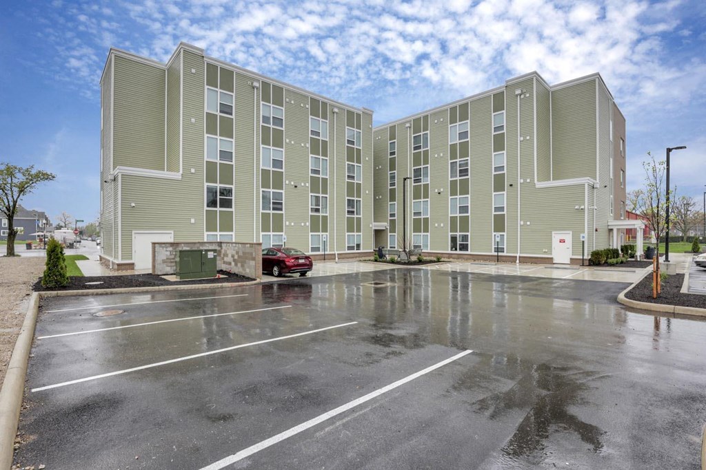 an empty parking lot in front of an apartment building