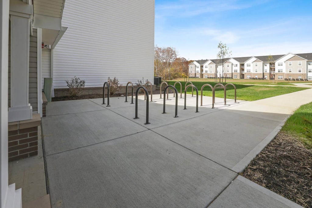 a sidewalk with bike racks in front of a building