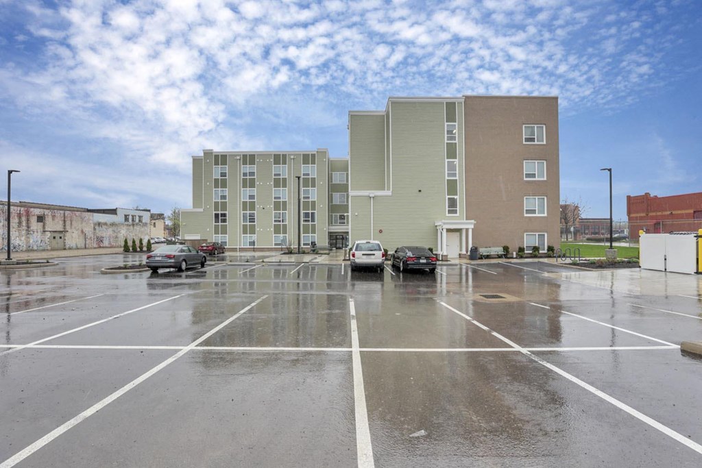 a parking lot with cars in front of a building