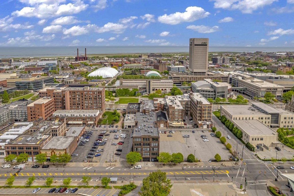 an aerial view of a city with a large white building in the middle