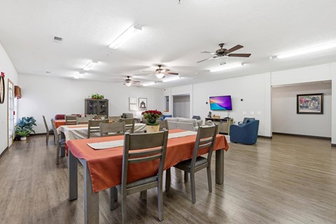 A dining room with a table set for six people.