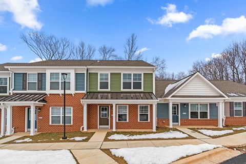A row of houses with snow on the ground.
