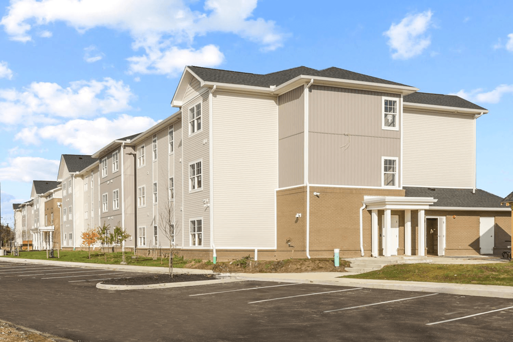 a row of new apartment buildings in a parking lot
