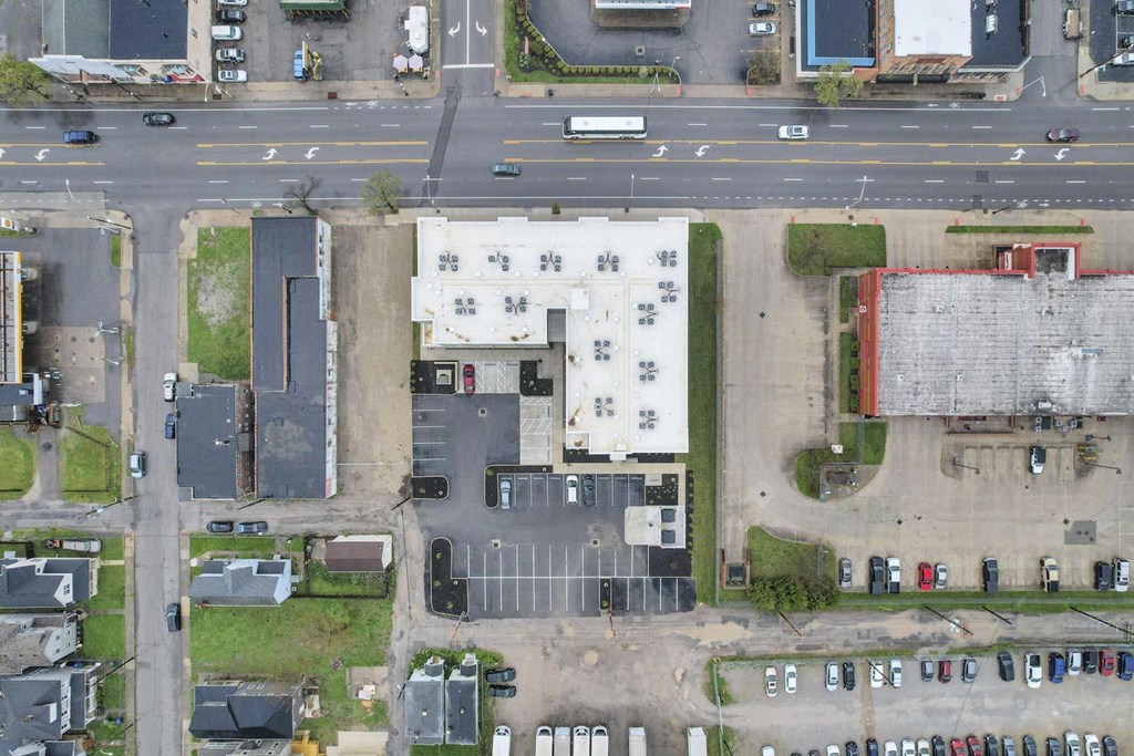an aerial view of a building in a parking lot