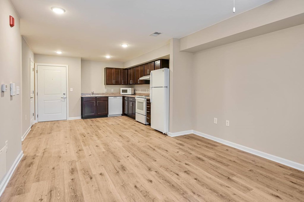 A kitchen area with a refrigerator, microwave, and oven.