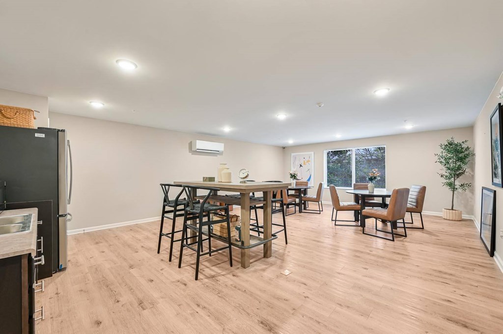 A kitchen with a dining table and chairs.