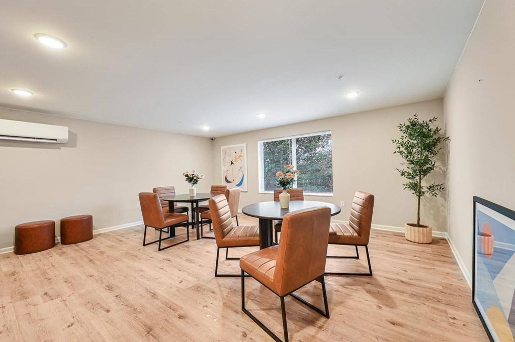 A dining room with a table and chairs.