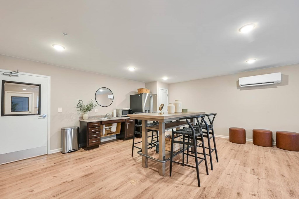 A dining area with a wooden table and chairs.