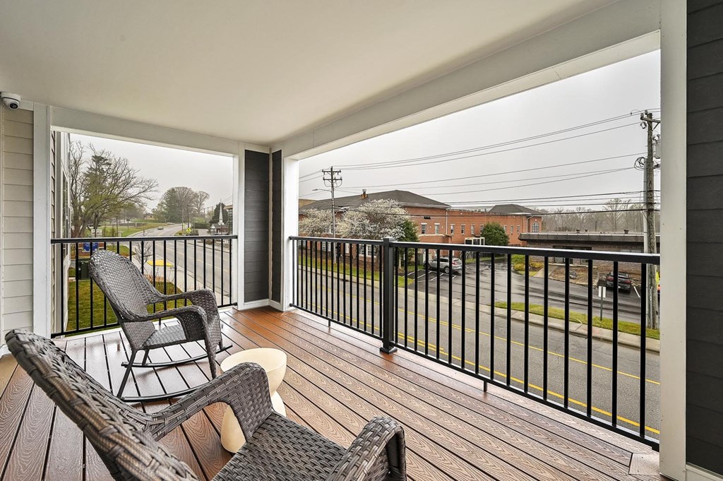 A balcony with a chair and a table.