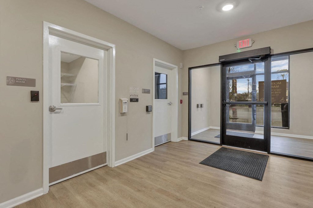the entrance of a building with doors and a wood floor
