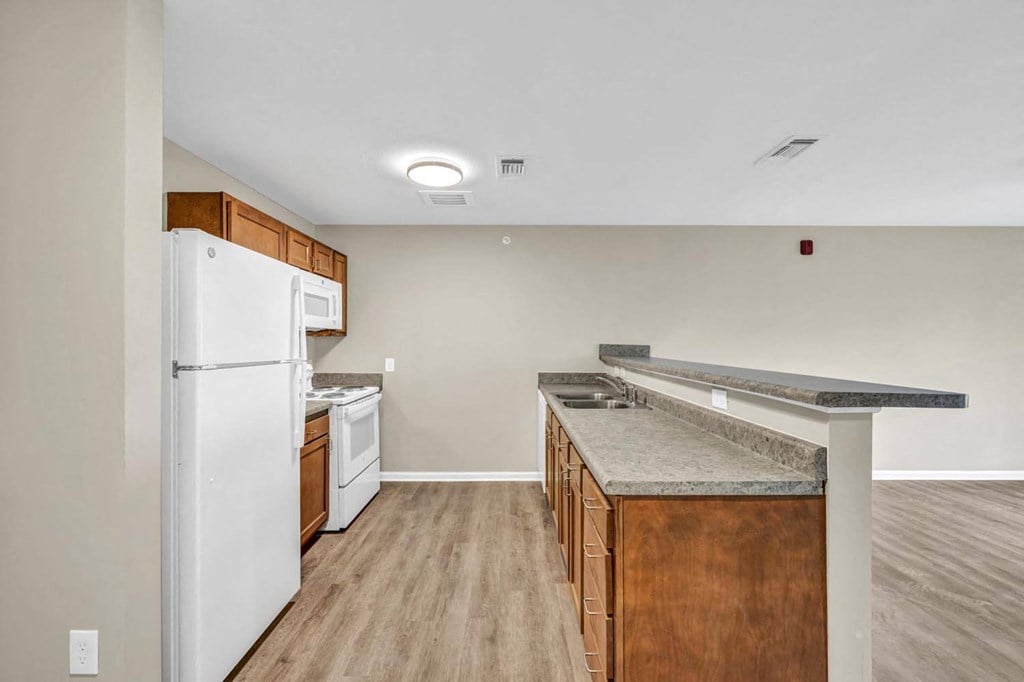 a kitchen with an island and a white refrigerator