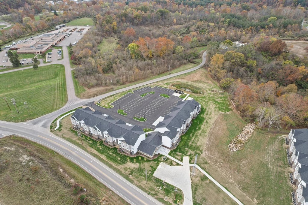 an aerial view of a building with solar panels on the roof