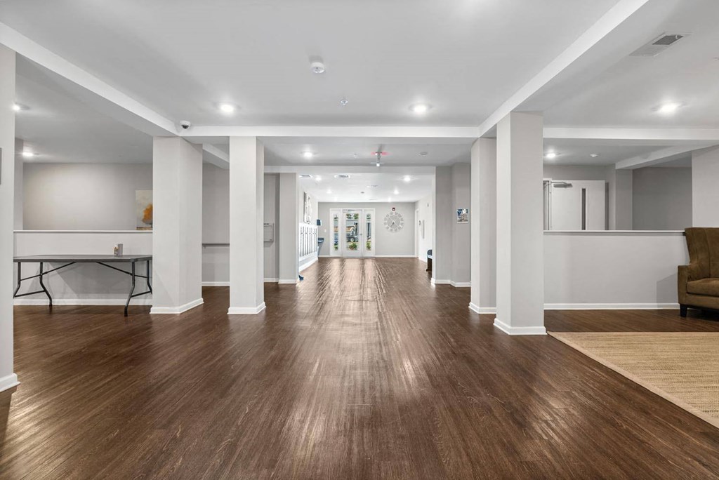 a large room with a wooden floor and white walls