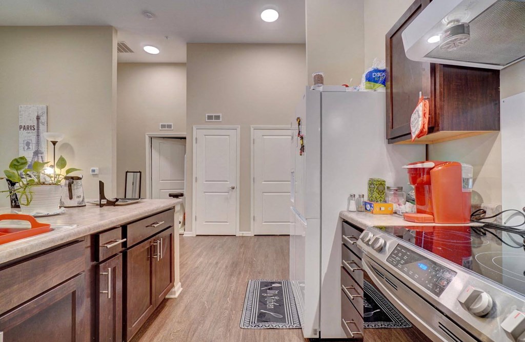 a kitchen with wooden cabinets and stainless steel appliances