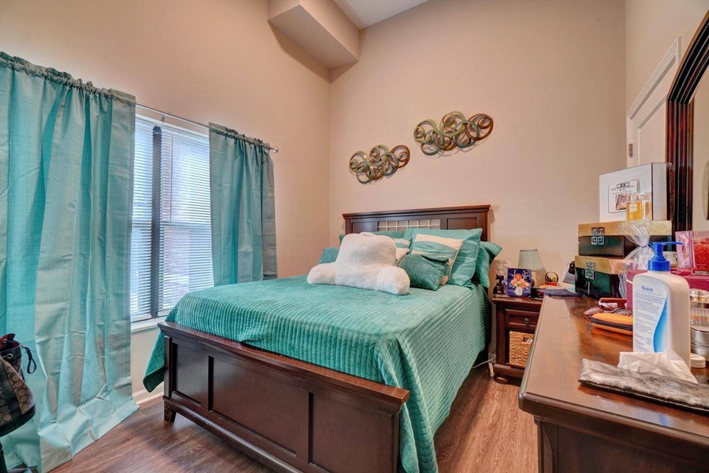 a bedroom with a bed and a window