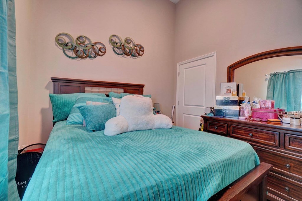 a bedroom with a bed and a dresser