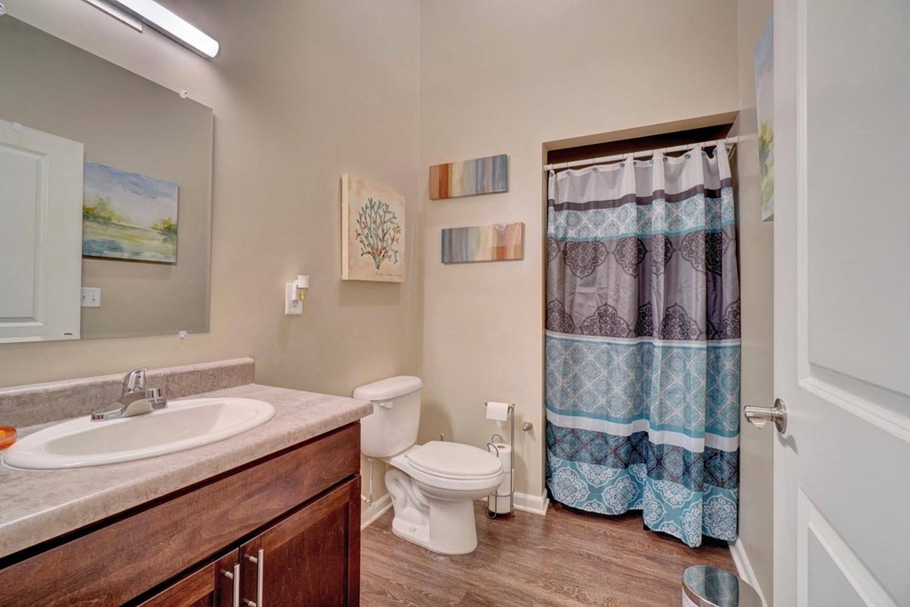 a bathroom with a toilet sink and shower