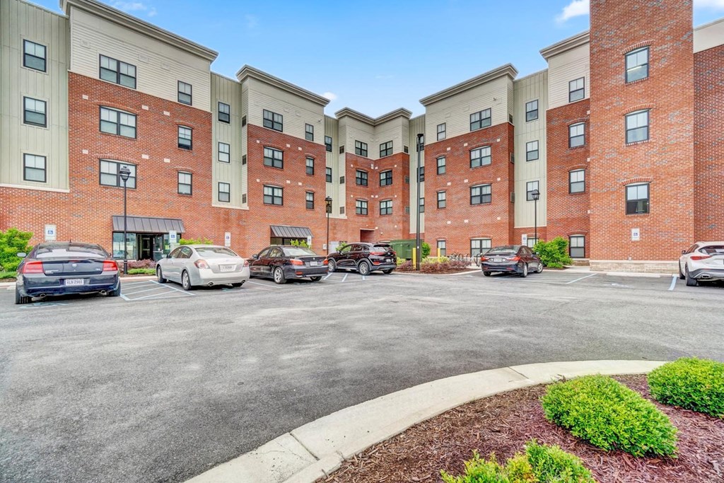 a large brick building with a parking lot in front of it