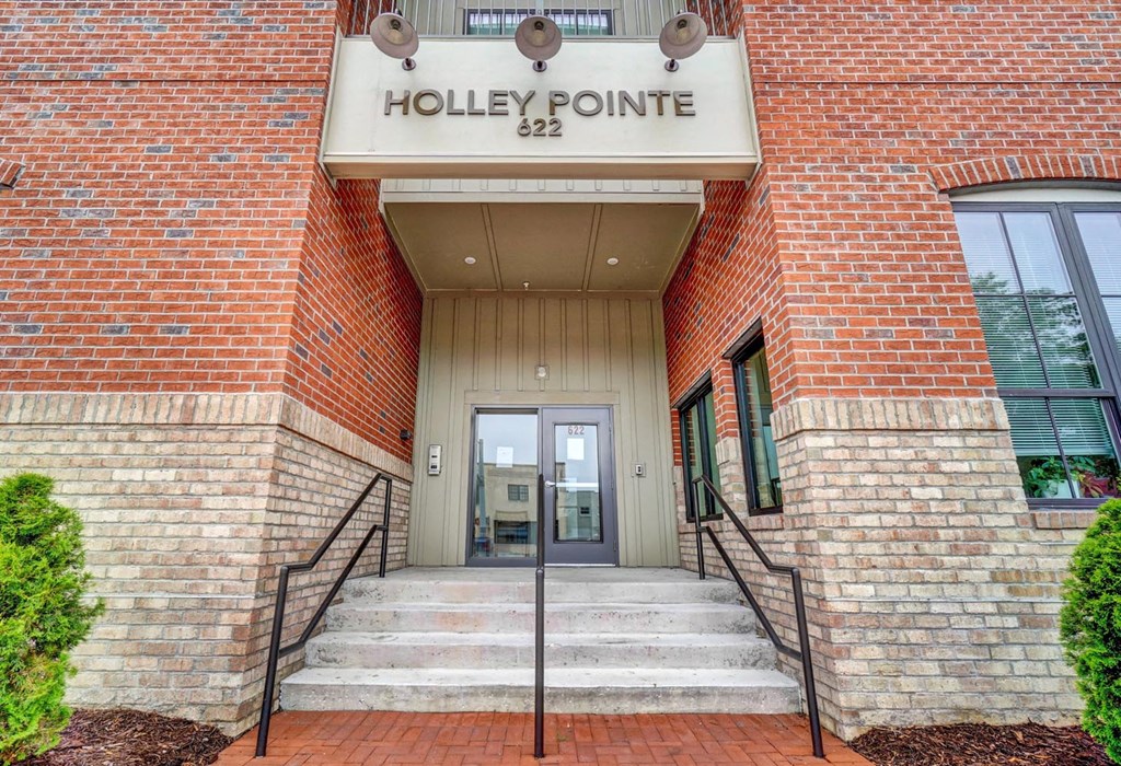 a brick building with a sign that says holly pointe