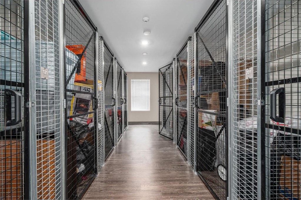 a long hallway filled with wire cages
