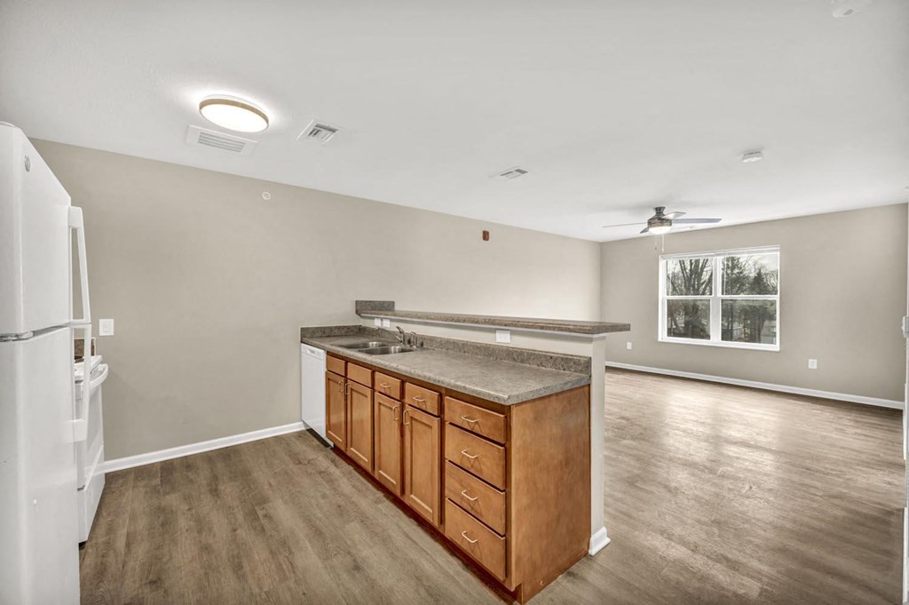 a kitchen with a counter top and a refrigerator