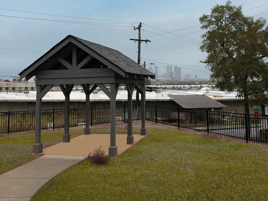 a gazebo with a view of the water and a city in the