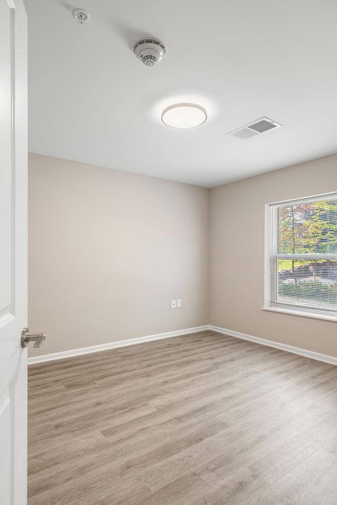 A room with a window and a door.