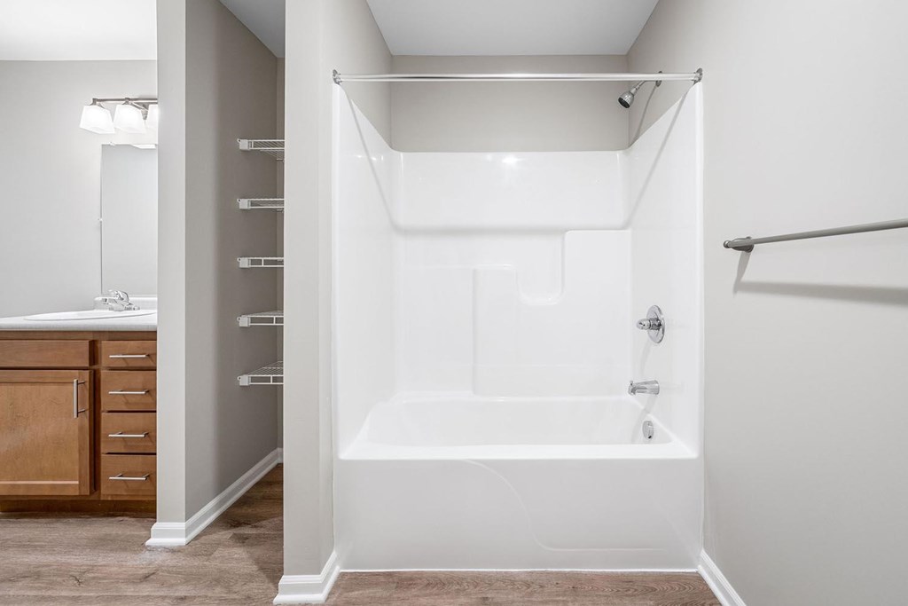 A white bathroom with a tub and a walk-in shower.