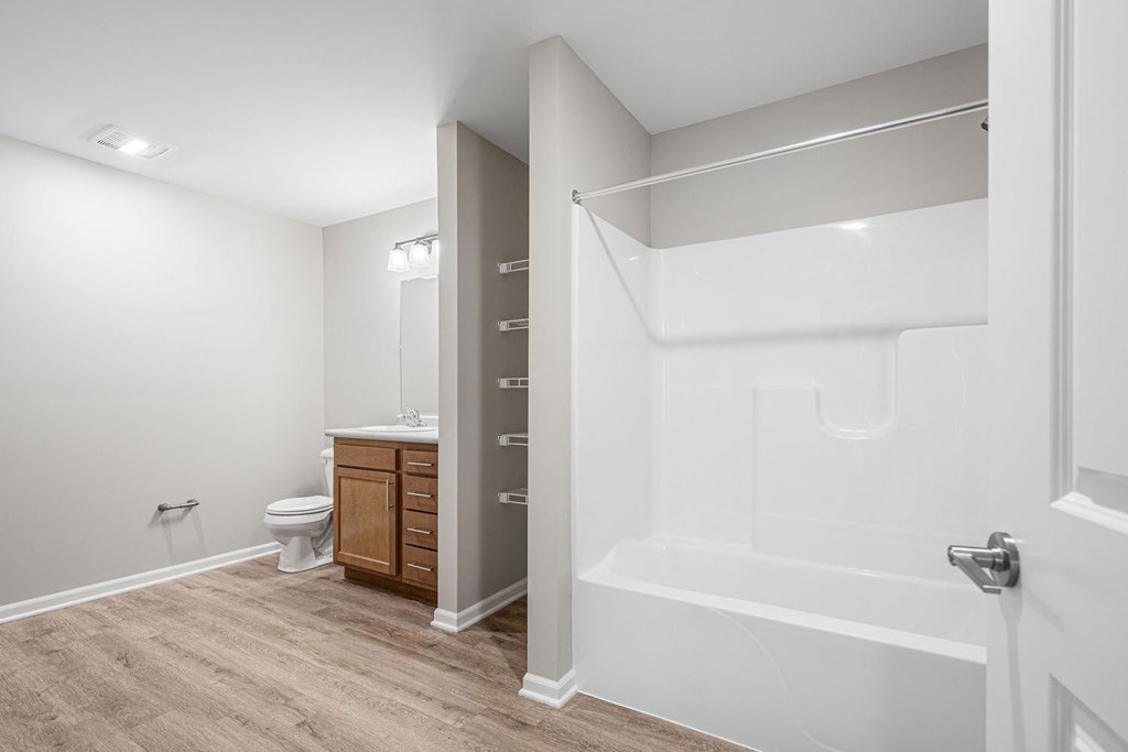 A white bathroom with a toilet, sink, and bathtub.