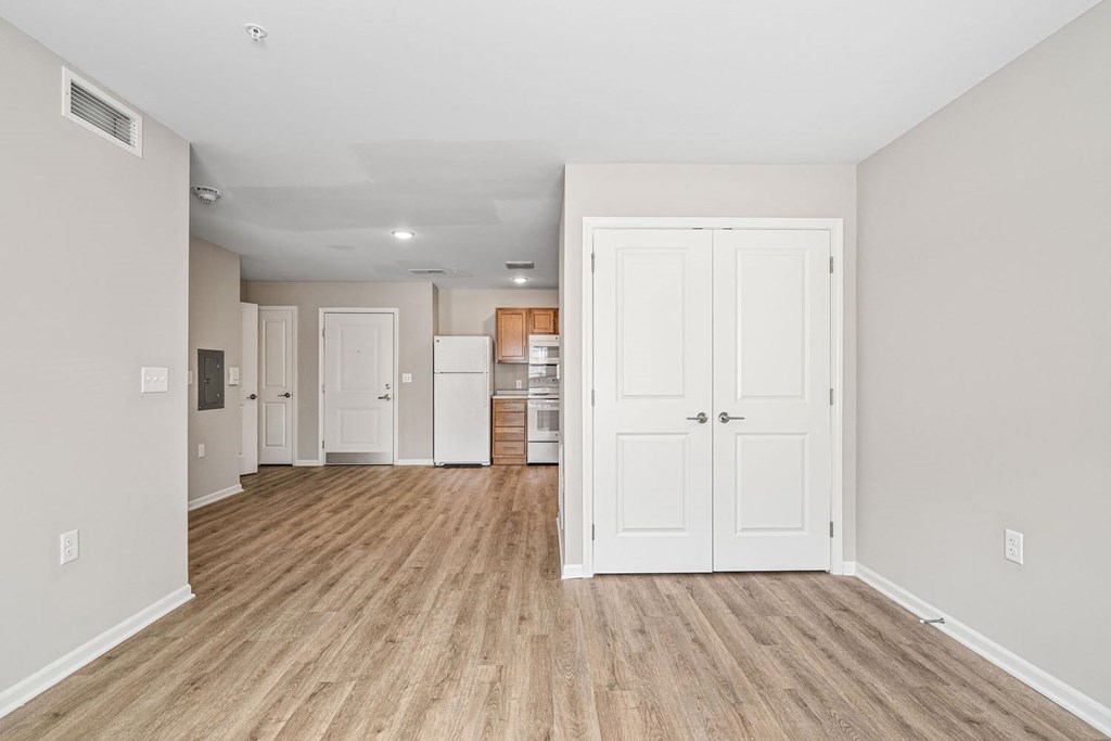 A room with wooden floors and white walls.