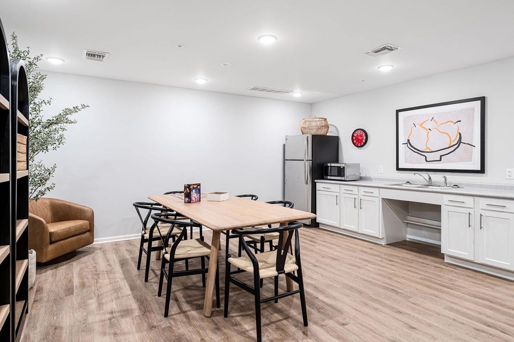 A dining room with a table and chairs.