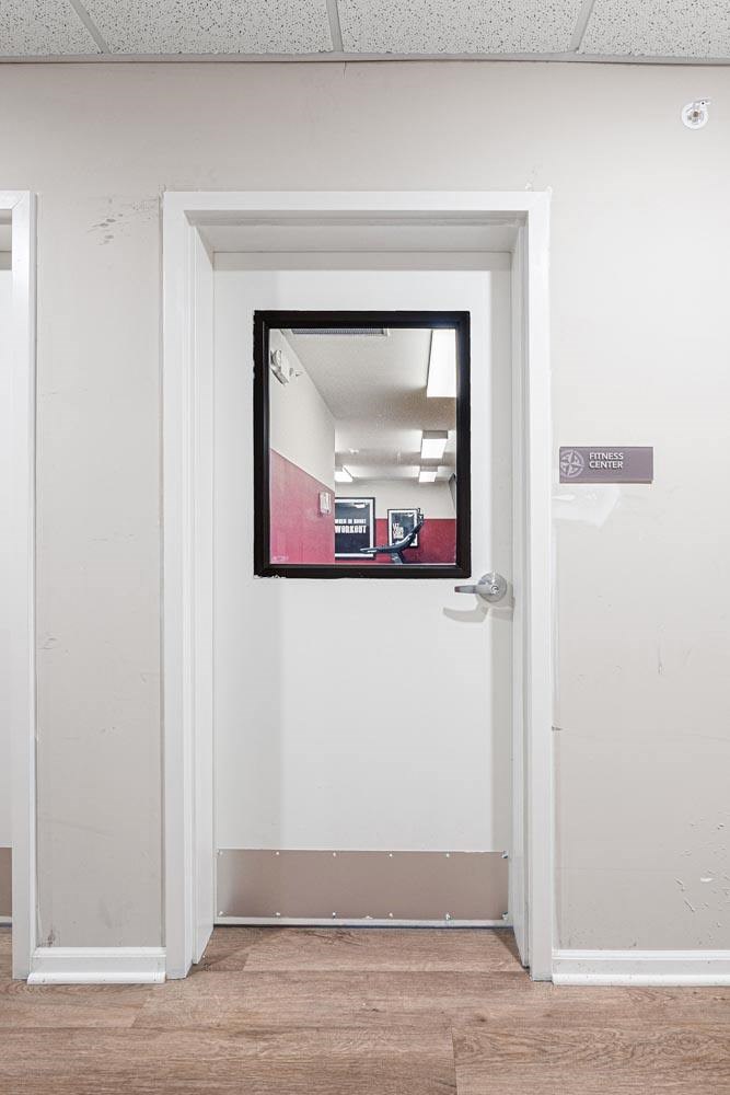 A white door with a mirror on it in a room.
