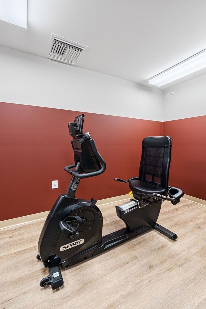 Two exercise bikes are placed in a room.