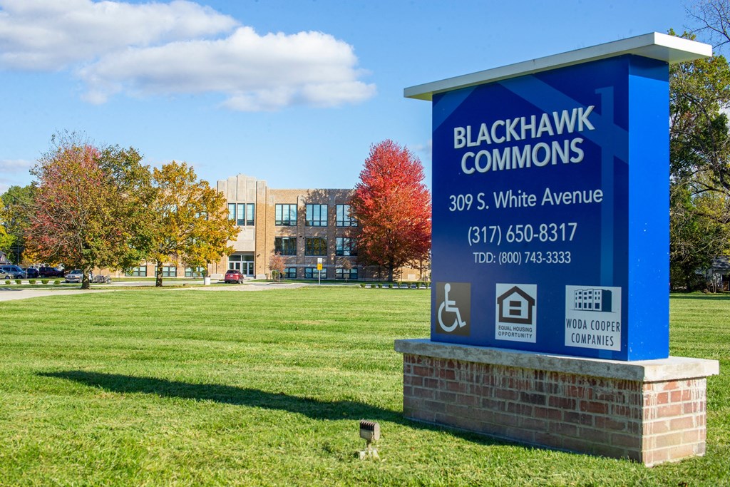 a sign for blackhawk commons in front of a building