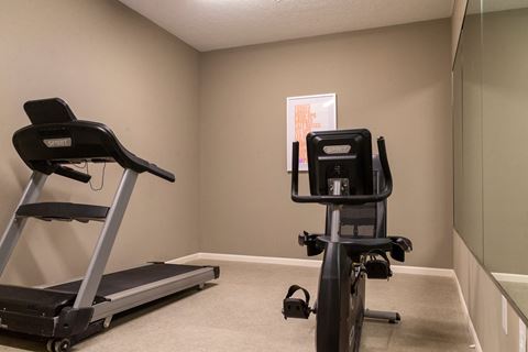 a home gym with two exercise bikes
